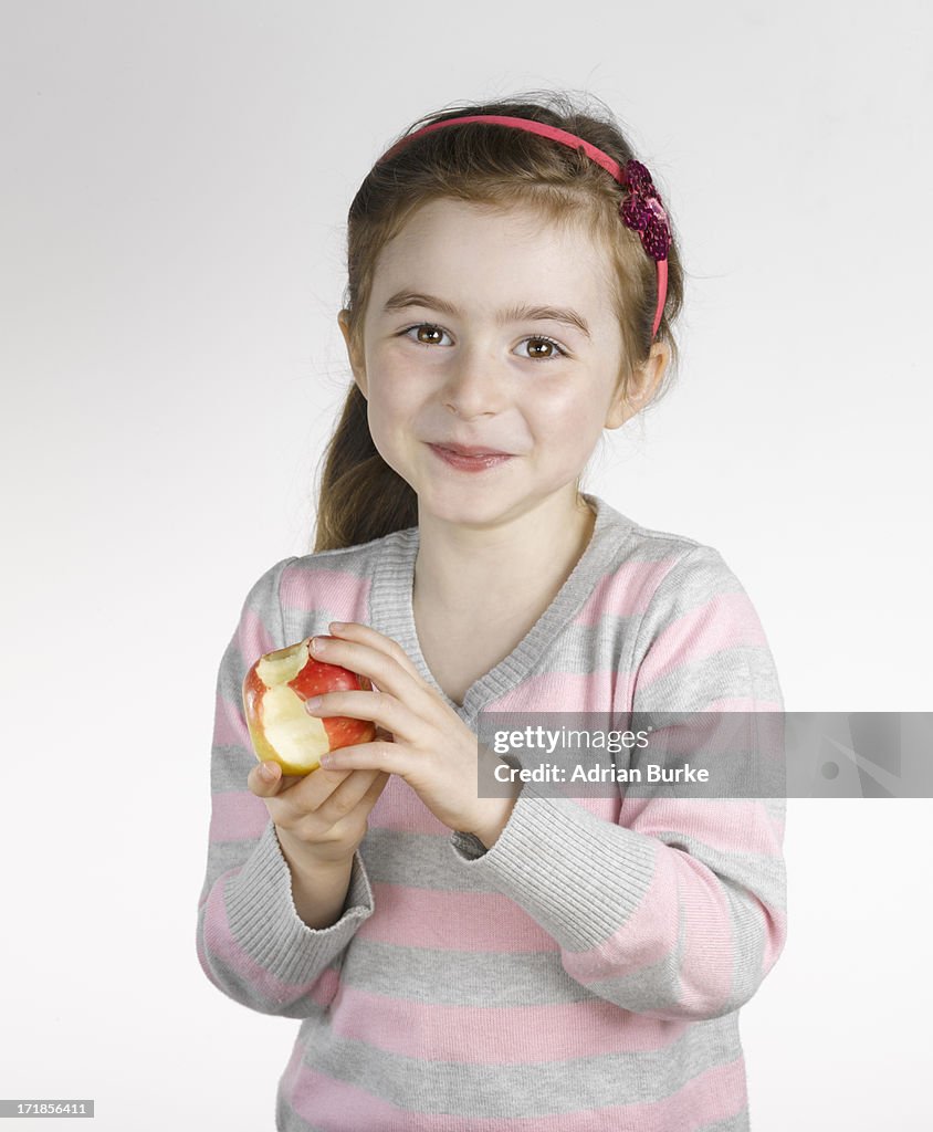 Small Girl Eating an apple.
