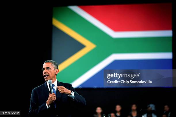 President Barack Obama takes questions from the audience and from people in Nigeria, Uganda and Kenya via live link during a "town hall" meeting with...