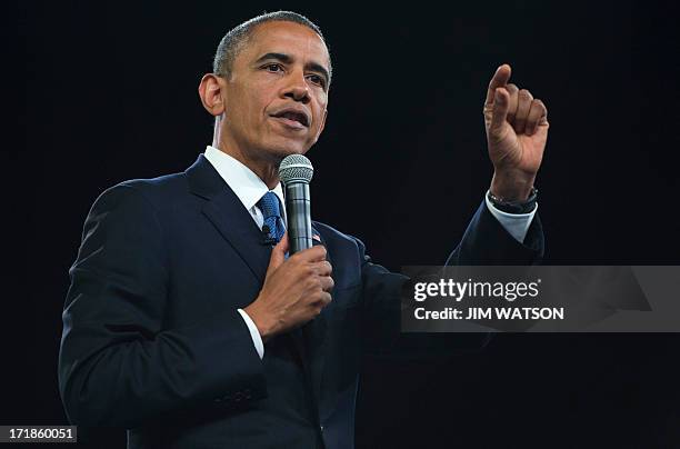 President Barack Obama gestures as he speaks during a town hall style meeting at the University of Johannesburg Soweto in Johannesburg, South Africa,...