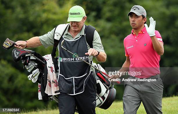 Pablo Larrazabal of Spain walks with his caddie John Curtis on the ninth hole during the third round of the Irish Open at Carton House Golf Club on...