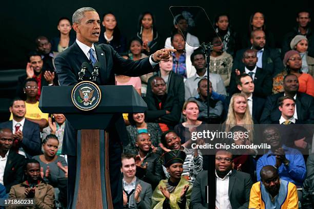 President Barack Obama takes questions from the audience and from people in Nigeria, Uganda and Kenya via live link during a "town hall" meeting with...