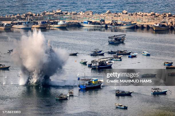 Shells from Israeli bombardment land in the water in the Gaza City seaport on October 11, 2023. Israel declared war on Hamas on October 8 following a...