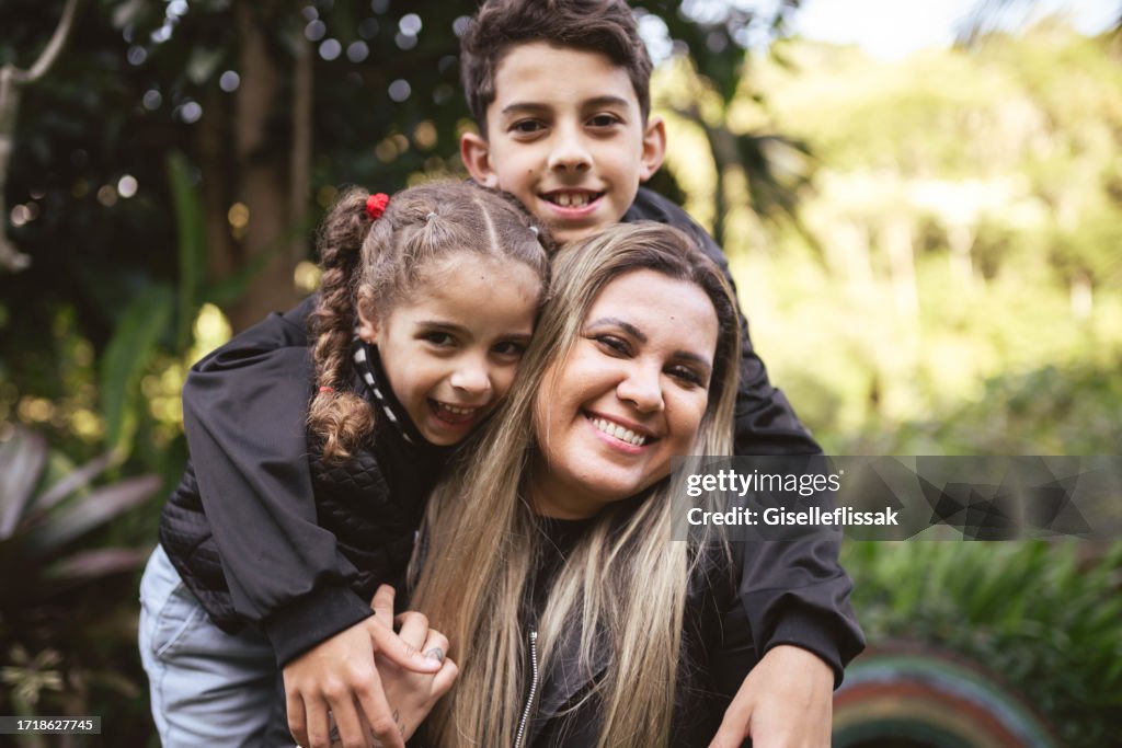 Portrait of happy mother with her children in the park