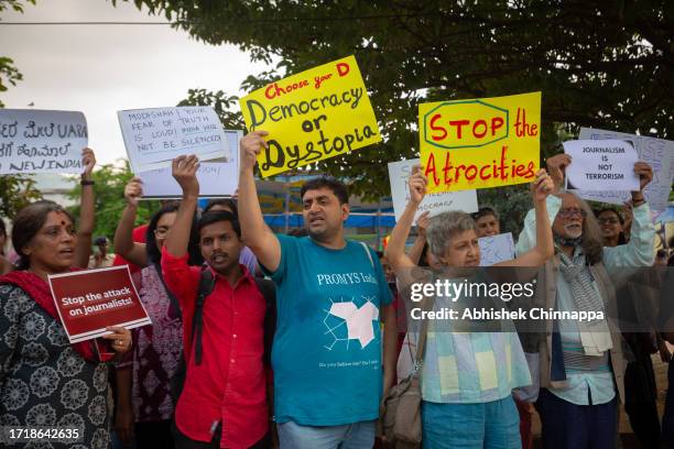 People wave placards and chant slogans as they protest against the arrest of NewsClick’s founder and editor-in-chief Prabir Purkayastha and Amit...