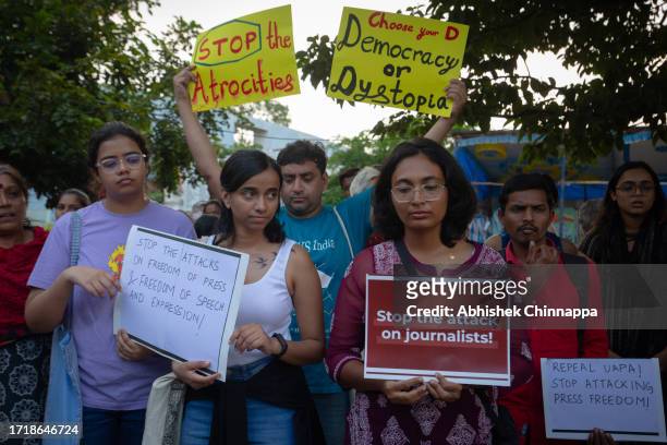 People wave placards and chant slogans as they protest against the arrest of NewsClick’s founder and editor-in-chief Prabir Purkayastha and Amit...
