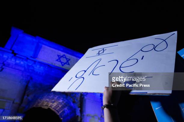 Protester holding a placard in support to Israel during the torchlight procession in support of Israel organized by the newspaper 'Il Foglio' at the...