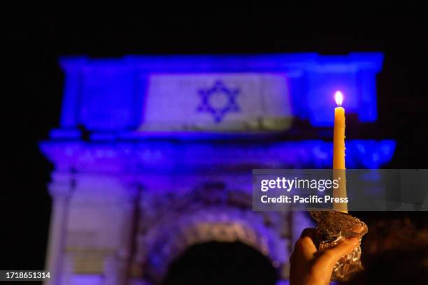 Protester holding a candle participates in a torchlight procession in support of Israel organized in Rome by the newspaper 'Il Foglio' at the Arco di...