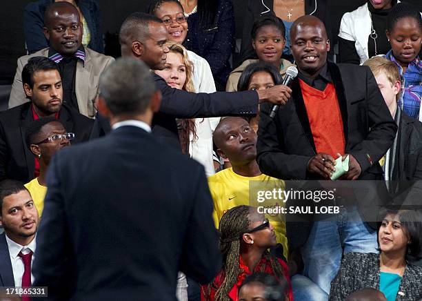 President Barack Obama listens to a question during a town hall meeting at the University of Johannesburg Soweto in Johannesburg, South Africa, on...