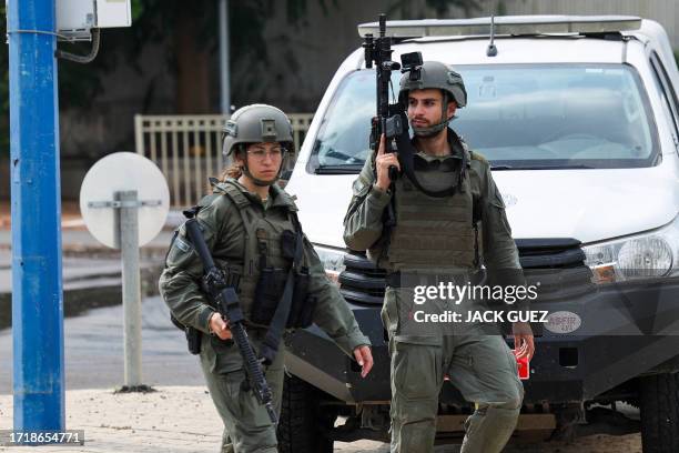 Members of the Israeli security forces patrol along a street in Sderot near the Israel-Gaza border on October 11, 2023. Israel declared war on Hamas...