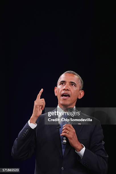 President Barack Obama answers questions from the audience and from people in Nigeria, Uganda and Kenya via live video link during a "town hall"...