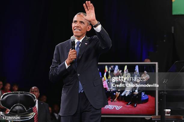 President Barack Obama answers questions from the audience and from people in Nigeria, Uganda and Kenya via live video link during a "town hall"...