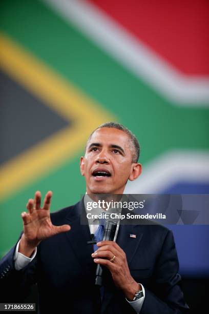 President Barack Obama answers questions from the audience and from people in Nigeria, Uganda and Kenya via live video link during a "town hall"...