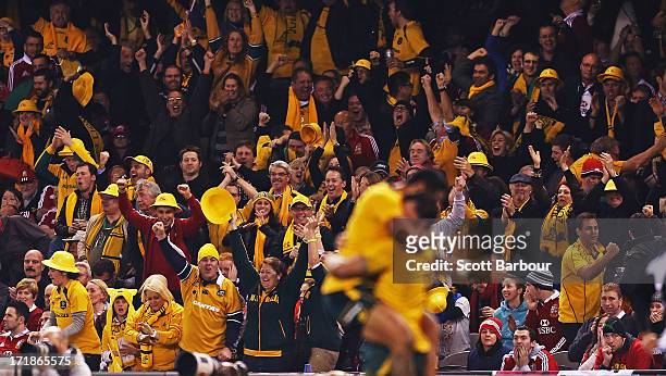 Wallabies supporters celebrate in the crowd as Adam Ashley-Cooper of the Wallabies celebrates with team mate Christian Lealiifano of the Wallabies...