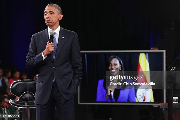 President Barack Obama answers questions from the audience and from people in Nigeria, Uganda and Kenya via live video link during a "town hall"...