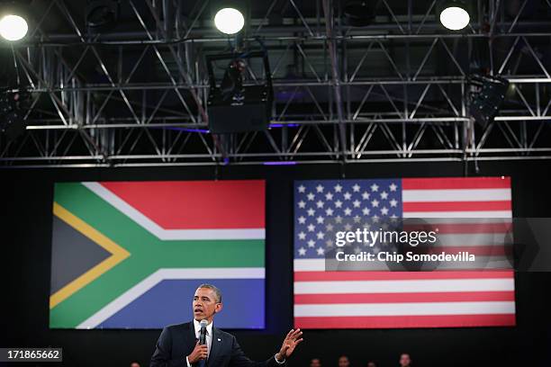 President Barack Obama answers questions from the audience and from people in Nigeria, Uganda and Kenya via live video link during a "town hall"...