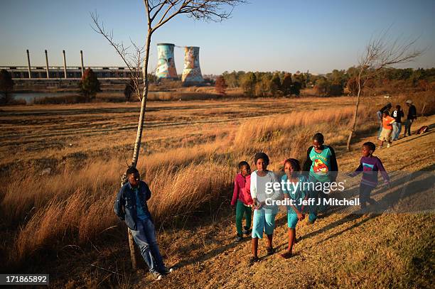 People await the departure of outside Johannesburg University in Soweto where President Obama's was meeting with students on June 29, 2013 in...