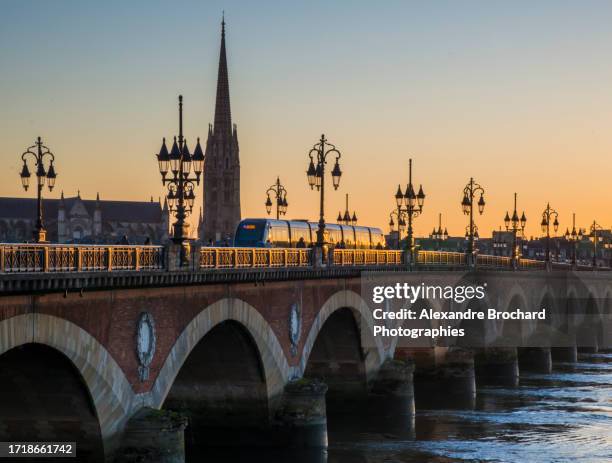 tramway on the stone bridge during sunset - bordeaux stock pictures, royalty-free photos & images