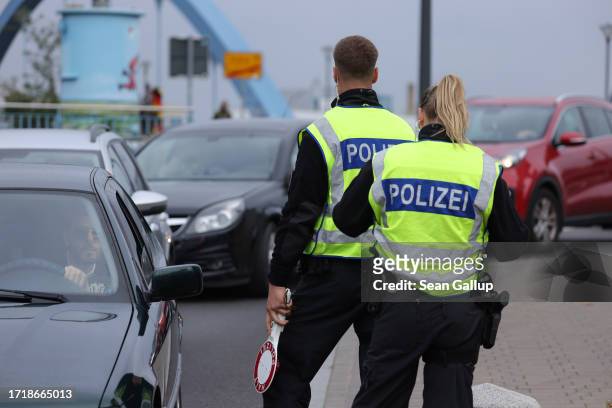 German police monitor vehicles arriving from Poland at a temporary border checkpoint on October 05, 2023 in Frankfurt an der Oder, Germany. Germany...