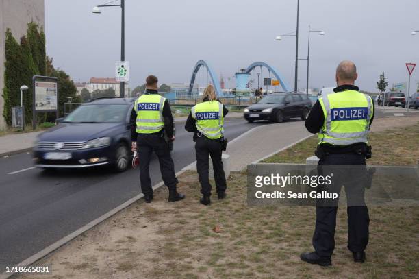 German police monitor vehicles arriving from Poland at a temporary border checkpoint on October 05, 2023 in Frankfurt an der Oder, Germany. Germany...