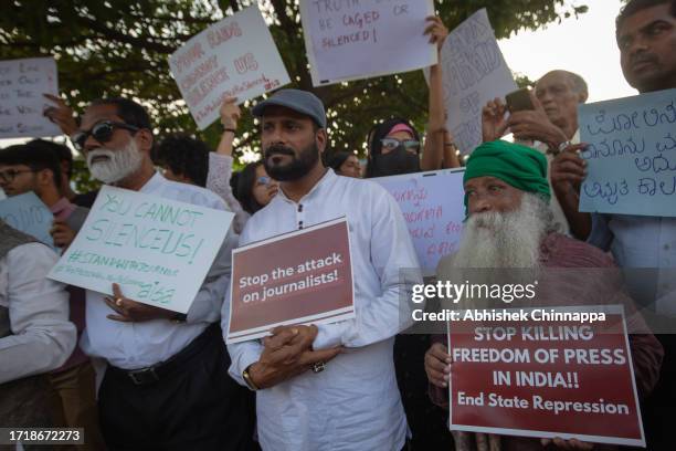 People wave placards and chant slogans as they protest against the arrest of NewsClick’s founder and editor-in-chief Prabir Purkayastha and Amit...