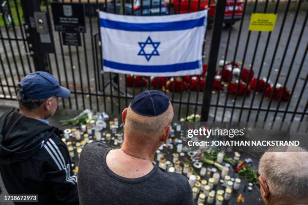 Man wears a Kippah as he reads the "Kaddish", a prayer that is an important part of Jewish mourning rituals, a way for mourners to express their...