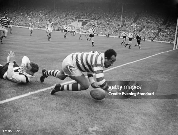 Wigan's Billy Boston scoring a try during the rugby league Challenge Cup final at Wembley Stadium in London, 9th May 1959. On the ground at left is...