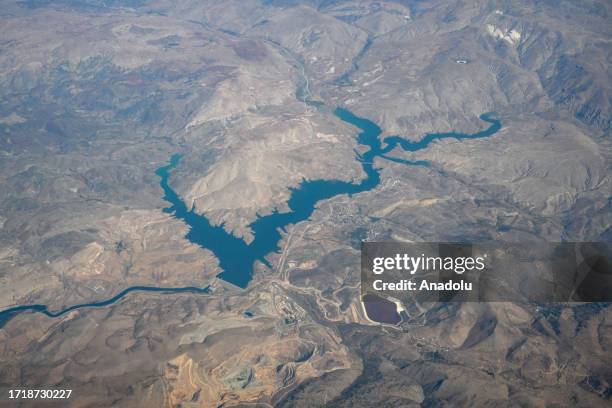 An aerial view of Bagishtas Dam on the Euphrates River, taken from an airplane traveling over Turkiye and Azerbaijan in Erzincan, Turkiye on...