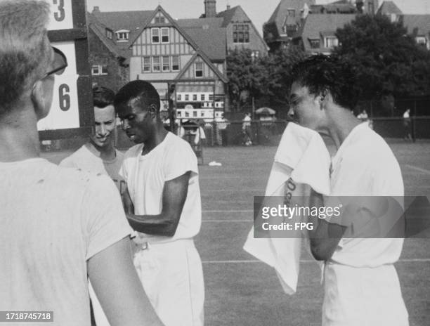 American tennis player Oscar Johnson and American tennis player Althea Gibson, who wipes her face with a towel, during the mixed doubles competition...