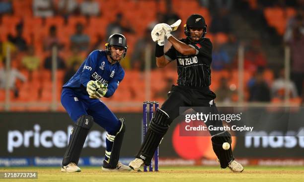 Rachin Ravindra of New Zealand plays a shot as Jos Buttler of England keeps during the ICC Men's Cricket World Cup India 2023 between England and New...