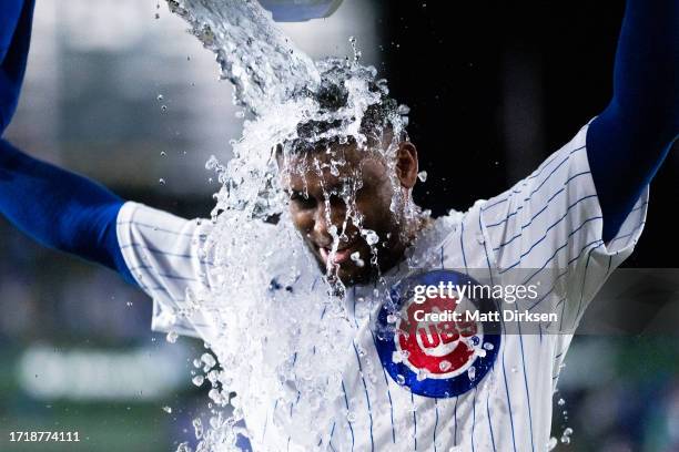 Alexander Canario of the Chicago Cubs gets doused with Gatorade following a game against the Pittsburgh Pirates at Wrigley Field on September 19,...