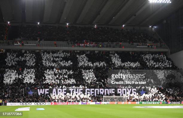 Fans of Newcastle United hold banners that reads 'Hello Hello We Are The Geordie Boys' prior to the UEFA Champions League match between Newcastle...