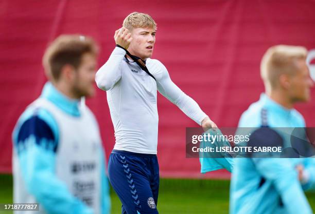 Denmark's Rasmus Hoejlund, Joachim Andersen and Kasper Dolberg react during the a training session in Helsingoer, Denmark on October 11 3 days ahead...