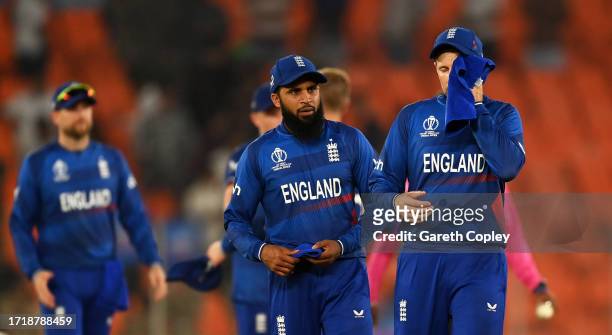 Adil Rashid and Joe Root of England cut a dejected figure following the ICC Men's Cricket World Cup India 2023 between England and New Zealand at...