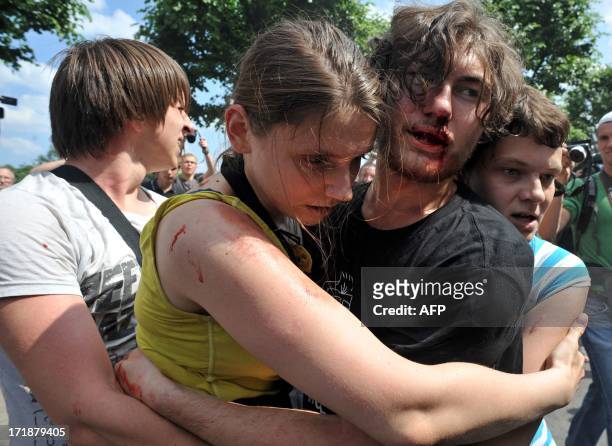 Gay rights activists embrace each other after clashes with anti-gay demonstrators during a gay pride event in St. Petersburg on June 29, 2013....