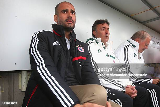Josep Guardiola, head coach of FC Bayern Muenchen looks on with his assistent coaches Domenec Torrent and Hermann Gerland during the friendly match...