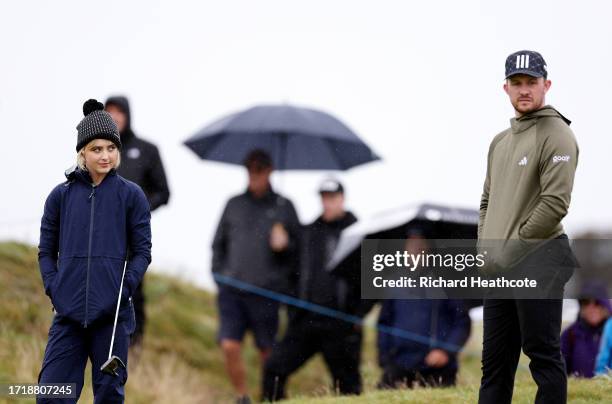 Actress, Kathryn Newton looks across to Connor Syme of Scotland on the third green during Day One of the Alfred Dunhill Links Championship at...