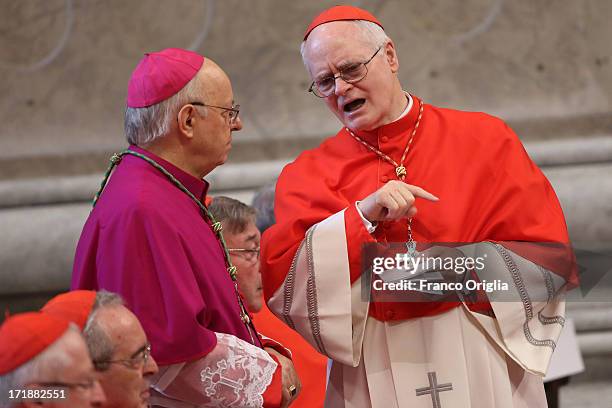 Archbishop of Sao Paulo, Cardinal Odilo Pedro Scherer chats with a bishop during the mass and imposition of the Pallium upon the new metropolitan...