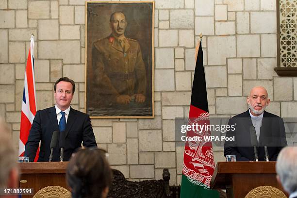 British Prime Minister David Cameron holds a press conference with President of Afghanistan Hamid Karzai in the Presidential Palace on June 29, 2013...