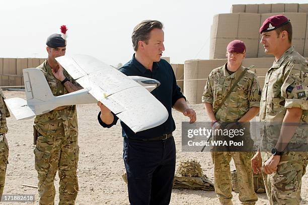 British Prime Minister David Cameron is shown a remote-controlled IED detection unit used in regional operations during a visit to Camp Bastion on...