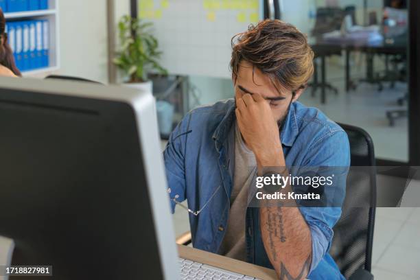 struggling with occupational stress. - rubbing eyes stock pictures, royalty-free photos & images