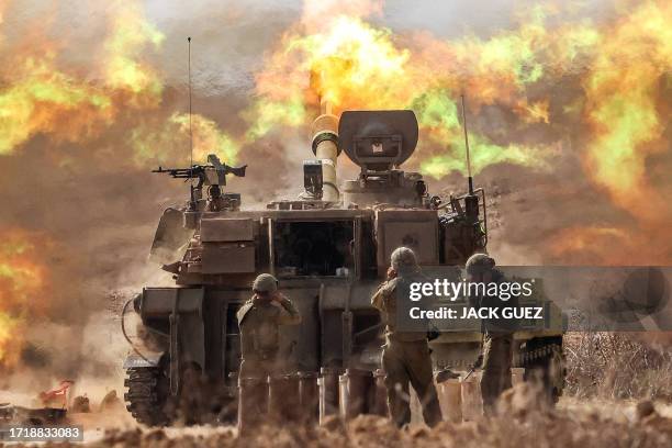 An Israeli army M109 155mm self-propelled howitzer fires rounds near the border with Gaza in southern Israel on October 11, 2023. Israel declared war...