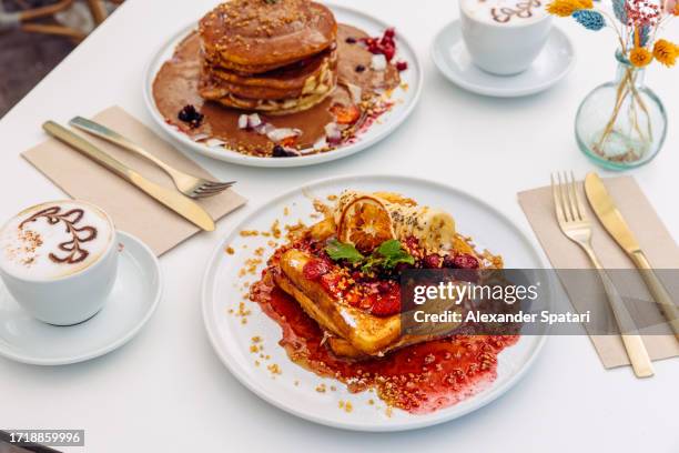 brunch with french toasts and pancakes served in a restaurant, side view - pain perdu stockfoto's en -beelden