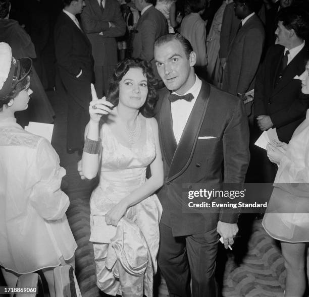 Italian actress Luciana Paluzzi with actor Stanley Baker at the film premiere of 'Sea Fury', London, August 26th 1958.