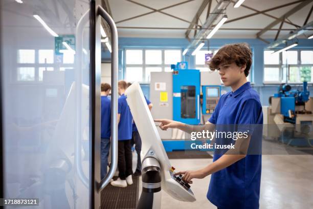 teenage boy operating cnc machine - teenage computer programmer stock pictures, royalty-free photos & images