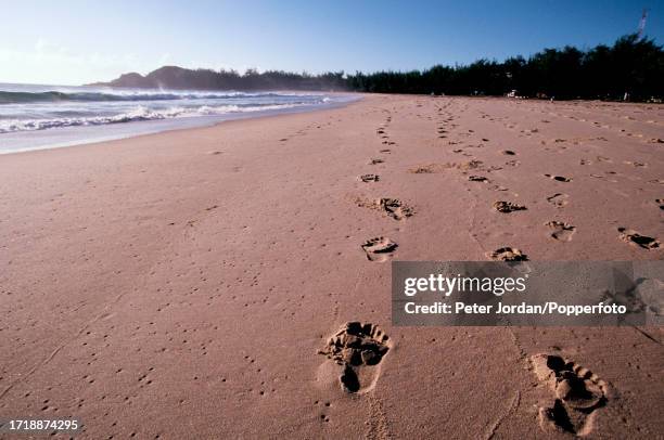 Footprints in the sand on a deserted Indian Ocean beach near the town of Tofo in Inhambane Province of Mozambique in Southern Africa on 11th May 2003.