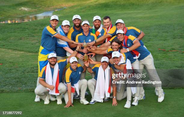 Luke Donald, Captain of Team Europe, and players of Team Europe pose with the Ryder Cup trophy following victory with a 16 and a half to 11 and a...