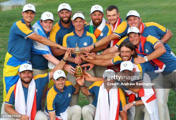 Luke Donald, Captain of Team Europe, and players of Team Europe pose with the Ryder Cup trophy following victory with a 16 and a half to 11 and a...