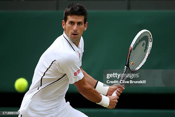 Novak Djokovic of Serbia plays a backhand during the Gentlemen's Singles third round match against Jeremy Chardy of France on day six of the...