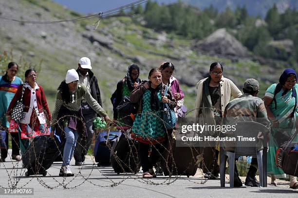 Pilgrims waiting for the helicopter to rescue them from Badrinath helipad on June 29, 2013 in Badrinath, India. People got stranded at Badrinath for...