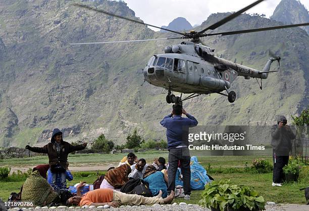 Pilgrims resting after been rescued from Badrinath at Joshimath helipad on June 29, 2013 in Joshimath, India. Continuous helicopter service rescuing...
